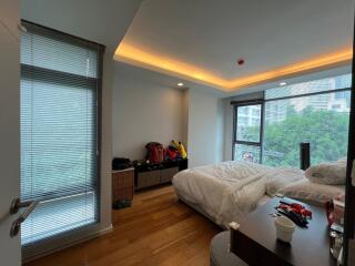 Modern bedroom with large windows and natural lighting