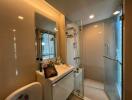 Modern bathroom with shower enclosure, sink, and large mirror