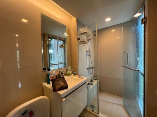 Modern bathroom with shower enclosure, sink, and large mirror