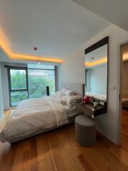 Modern bedroom with large windows and city view