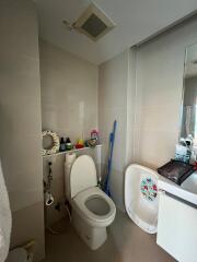 Modern bathroom with toilet, sink, and storage