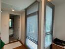 Modern hallway with wooden flooring and windows with blinds