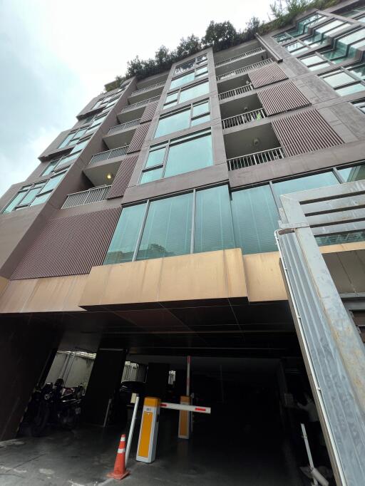 View of building exterior with glass windows and balconies