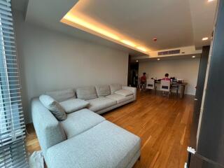 Spacious living room with gray sectional sofa and wooden floor