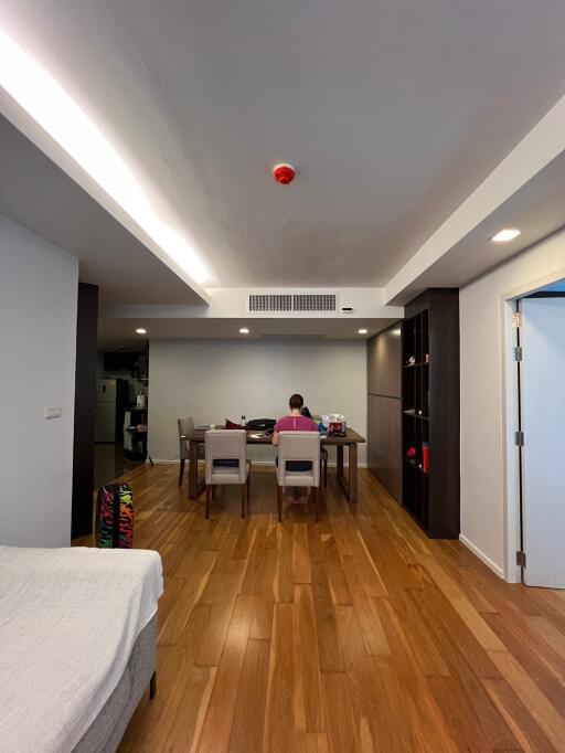 Modern living area with dining table and person working