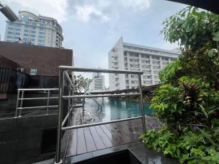 view of swimming pool area with city buildings in the background