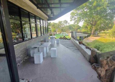 Modern outdoor patio area with seating and roof cover