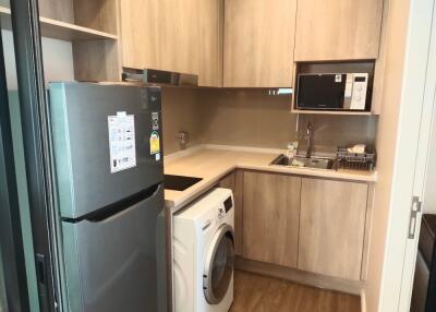 Modern kitchen with wooden cabinetry and appliances