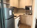 Modern kitchen with wooden cabinetry and appliances