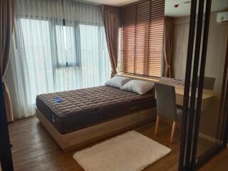 Modern bedroom with large windows and natural light