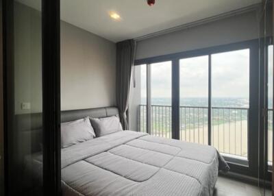 Bedroom with large windows and balcony view