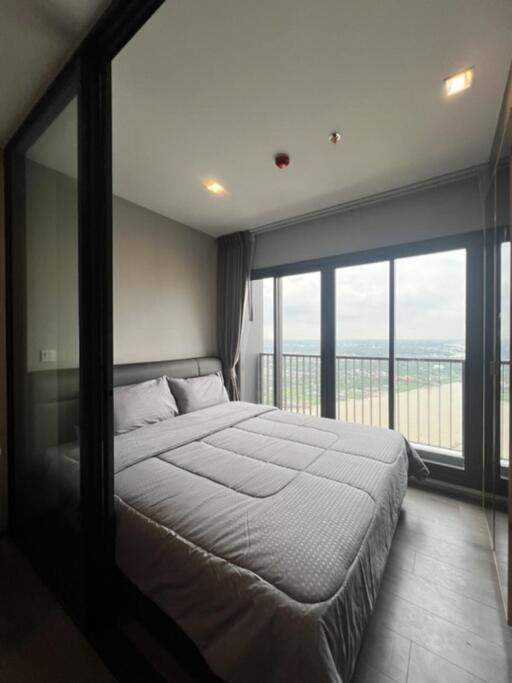 Bedroom with large windows and balcony view