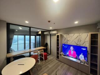 modern living room with a large TV and a view