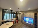 Modern living room with marble TV stand and large windows providing a view