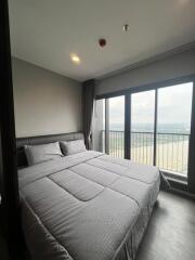 Bedroom with large windows and double bed