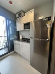 Modern kitchen with stainless steel appliances and balcony view