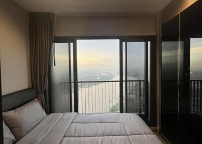 bedroom with large window and scenic view