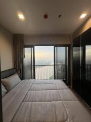 bedroom with large window and scenic view