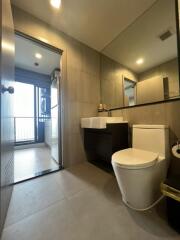 Modern bathroom with large mirror and white fixtures