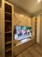 Modern living room with a TV and storage units.