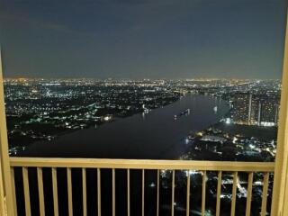 Night view from balcony overlooking river and cityscape