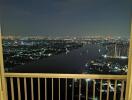 Night view from balcony overlooking river and cityscape