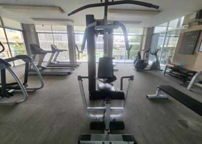 A well-equipped fitness room with a variety of exercise machines.