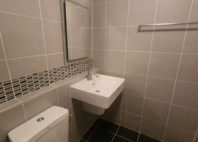 Modern bathroom with tiled walls and clean fixtures