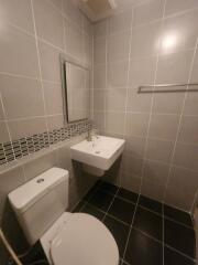 Modern bathroom with tiled walls and clean fixtures