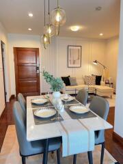 Modern dining area with a view into a cozy living room