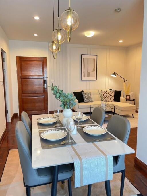 Modern dining area with a view into a cozy living room