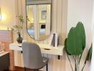 Stylish bedroom vanity area with a plant and mirror