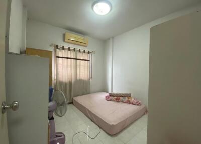 Simple bedroom with a mattress, window, and air conditioning unit