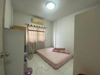 Simple bedroom with a mattress, window, and air conditioning unit