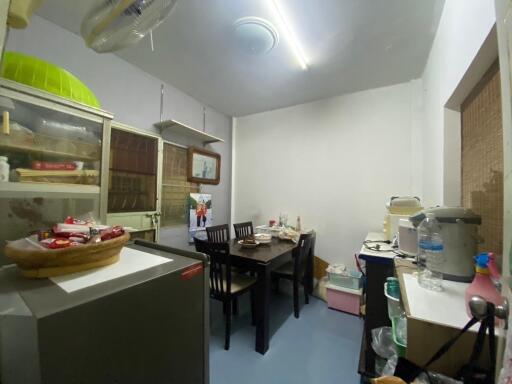 A cozy kitchen with a dining table and various storage solutions