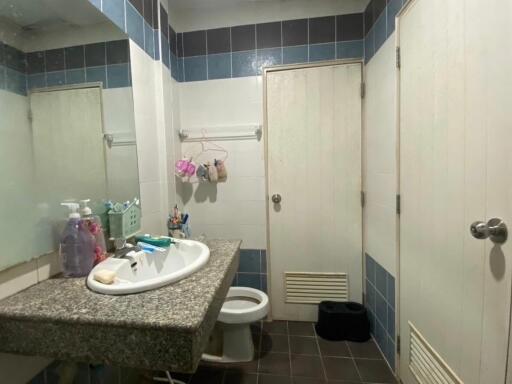 A clean bathroom with a sink, mirror, and toilet