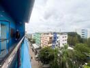 View from the balcony overlooking neighboring buildings and street