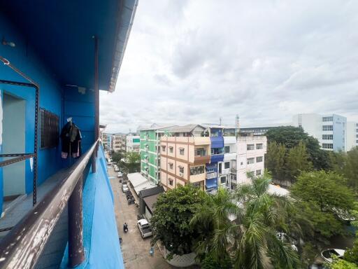 View from the balcony overlooking neighboring buildings and street