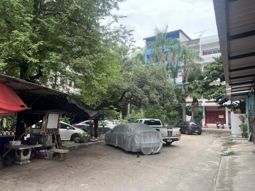 Parking lot with covered cars and greenery