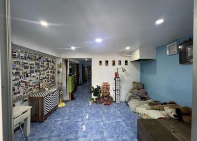 Spacious living room with blue tile flooring and wall decorations