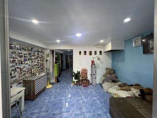 Spacious living room with blue tile flooring and wall decorations