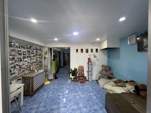 Spacious living room with blue tile flooring and wall decorations