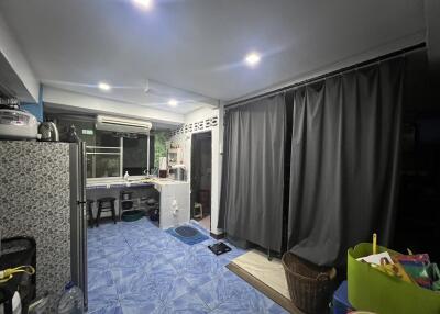 Modern kitchen with tiled floor and curtains