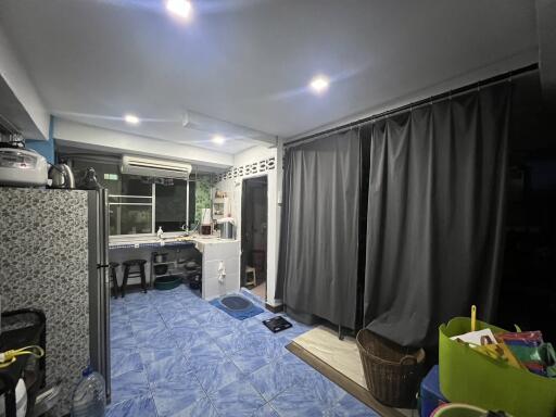 Modern kitchen with tiled floor and curtains