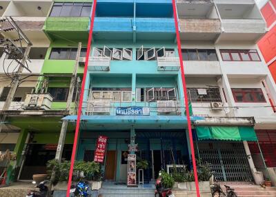 Four-story commercial building with vibrant blue facade