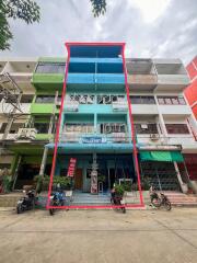 Four-story commercial building with vibrant blue facade