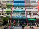 Four-story commercial building with vibrant blue facade