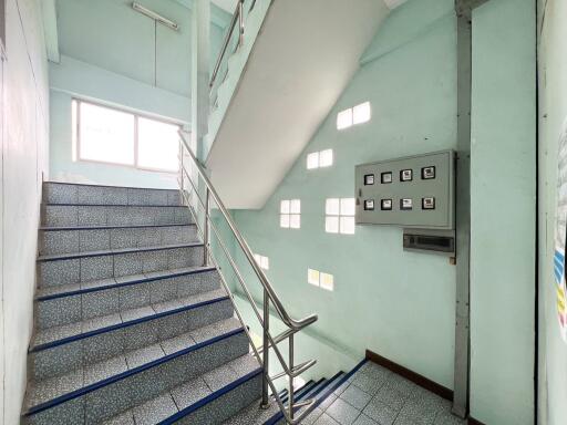 Staircase with railing and electrical panel