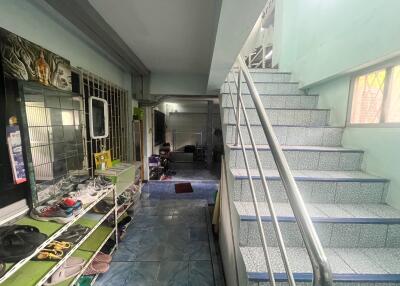 A view of the entryway and staircase in the property, showing a ground floor area and stairs leading to the upper floor.