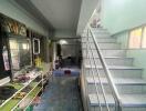 A view of the entryway and staircase in the property, showing a ground floor area and stairs leading to the upper floor.